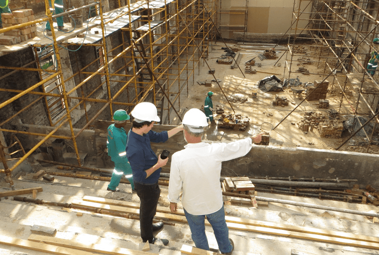 Two people overseeing work in a construction site