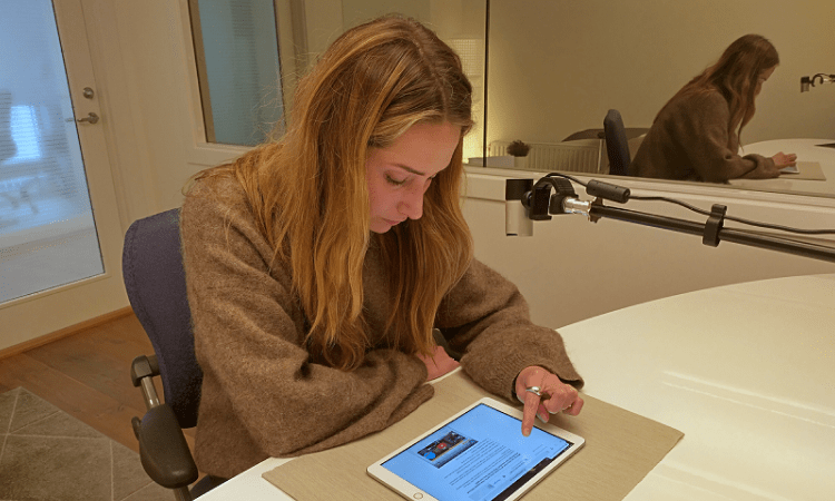 Person interacting with a tablet in a usability lab